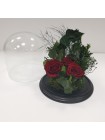 Композиция в стеклянной колбе с зеленью три бордовые розы